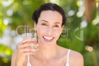 woman in white having a glass of water