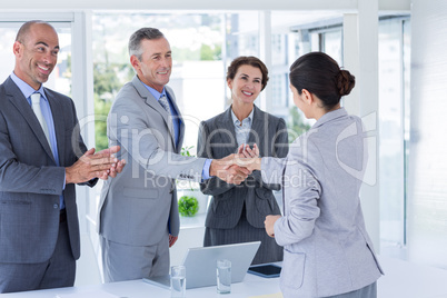 Interview panel shaking hands with applicant