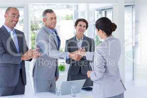 Interview panel shaking hands with applicant