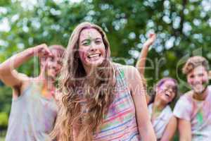 Happy women covered in powder paint