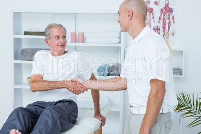 Patient shaking hands with doctor