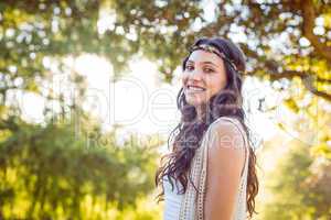 Pretty hipster smiling in the park