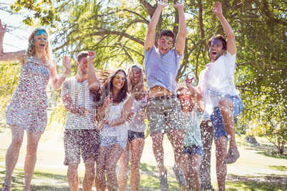 Happy friends jumping in the water