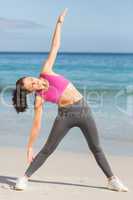 Fit woman doing fitness beside the sea