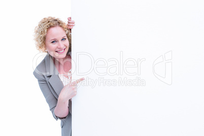 Woman pointing around blank sign