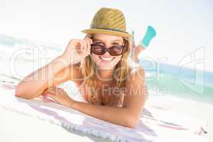 Pretty blonde relaxing beside the water looking at camera