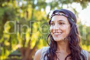 Pretty hipster smiling in the park