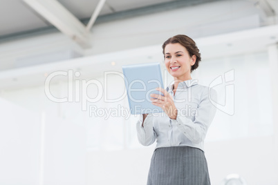Smiling businesswoman using her tablet Smiling businesswoman using her tablet