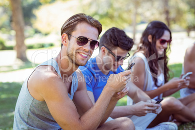 Handsome hipster using his smartphone
