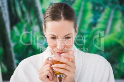 Close up of a beautiful young woman drinking tea