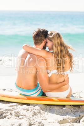 Happy couple in swimsuit embracing