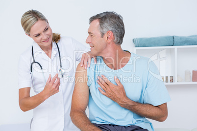 Doctor doing an injection to her patient