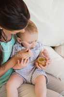 Happy mother eating with her baby boy