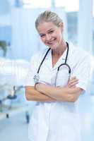 Beautiful smiling doctor standing arms crossed