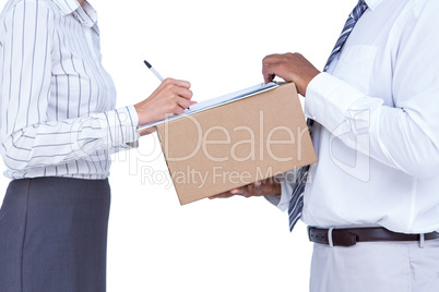 Businesswoman signing papers for package