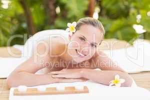 Peaceful blonde lying on towel