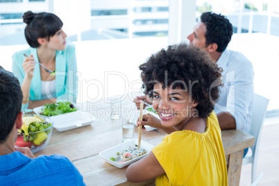 Smiling businesswoman having lunch