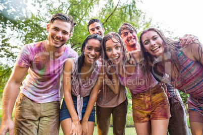 Happy friends covered in powder paint