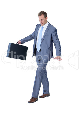 Businessman walking in equilibrium with suitcase