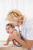 Blonde doctor with stethoscope and child