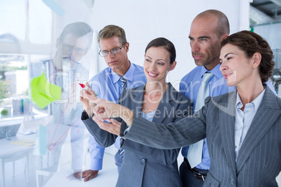 Businesswoman drawing graph on the board