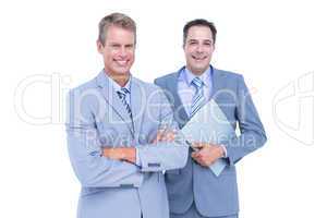 Business team standing arms crossed and with a folder