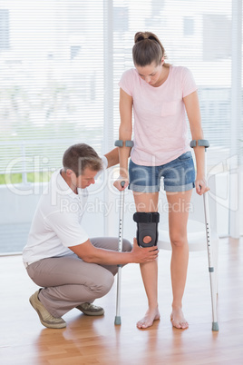 Doctor examining his patient knee