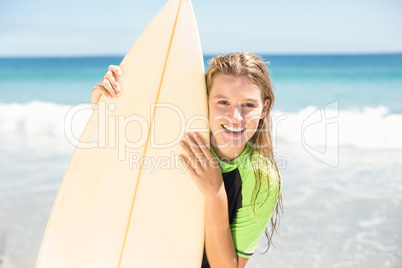 Pretty blonde woman holding surf board