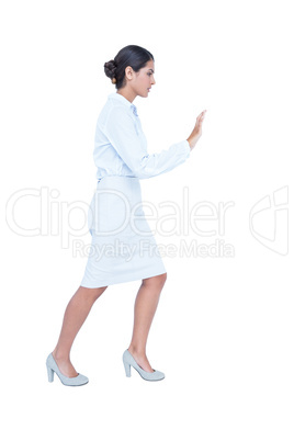 Businesswoman standing and pushing