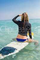 woman with a surfboard on a sunny day