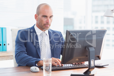 Serious businessman on his pc