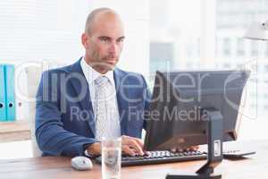 Serious businessman on his pc