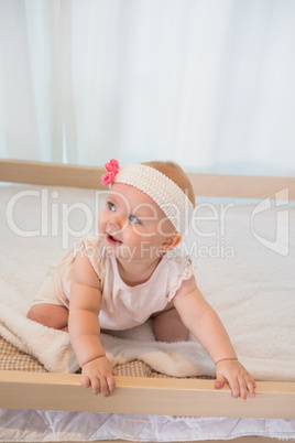 Beautiful baby girl in his bed