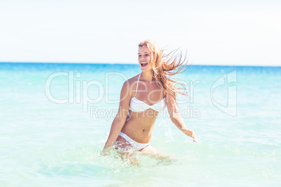 Happy pretty blonde bathing into the sea