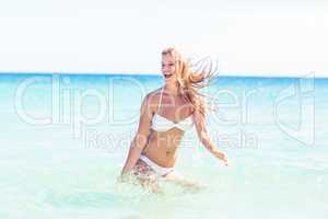 Happy pretty blonde bathing into the sea