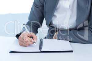 Businesswoman writing in her diary