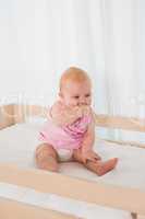 Beautiful cute baby girl in her bed