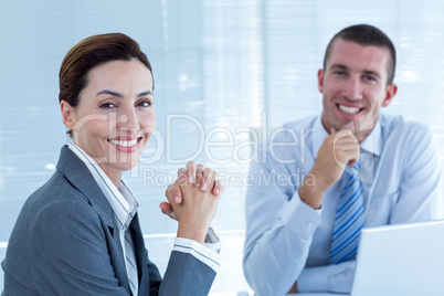 Smiling business people looking at camera