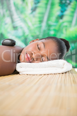 Pretty woman enjoying a hot stone massage