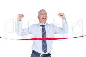 Happy businessman crossing red line