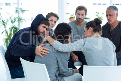 Concerned patients comforting another in rehab group