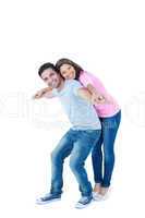 Happy man giving his girlfriend piggy back