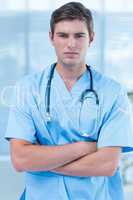 Unsmiling doctor looking at camera