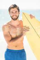 Handsome man holding surfboard