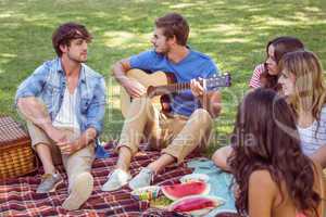 happy friends in the park having picnic