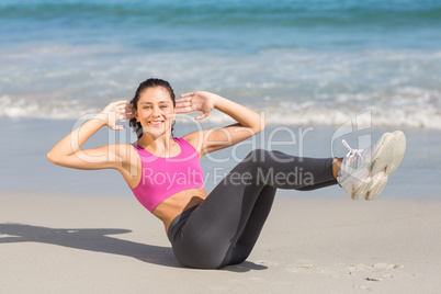 Fit woman doing fitness beside the sea