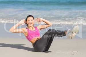 Fit woman doing fitness beside the sea