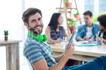 Smiling young man using digital tablet