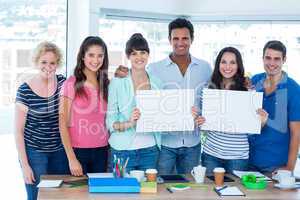 Creative business team holding signboard