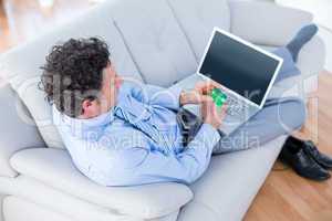 Businessman doing online shopping on couch